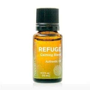 Refuge Calming Essential Oil Blend bottle surrounded by calming botanicals, representing natural stress relief and emotional balance.