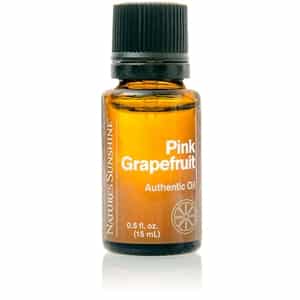 Pink Grapefruit Essential Oil bottle with fresh grapefruit slices, showcasing its uplifting citrus scent and purifying wellness benefits.