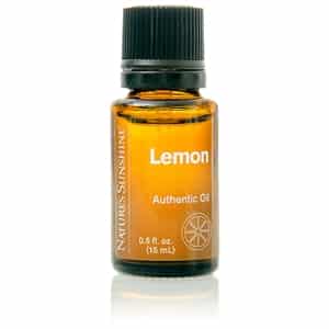 Lemon Essential Oil bottle with fresh lemon slices, highlighting its uplifting citrus aroma and natural cleansing benefits.