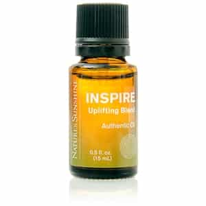 Inspire Uplifting Essential Oil Blend bottle with citrus and mint botanicals, symbolizing natural energy and mood support.