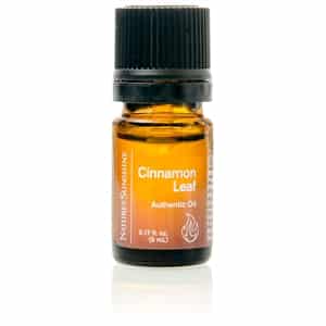Cinnamon Leaf Essential Oil bottle with cinnamon leaves and bark, highlighting its spicy aroma and immune-supporting, purifying benefits.